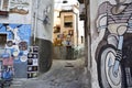 Narrow street in historic center of Orgosolo decorated by local artists wall paintings