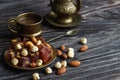Oriental Arabian sweets with different nuts a cup of coffee. Eastern sweets. Traditional Turkish delight Rahat lokum on a wooden Royalty Free Stock Photo