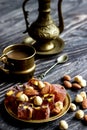 Oriental Arabian sweets with different nuts a cup of coffee. Eastern sweets. Traditional Turkish delight Rahat lokum on a wooden