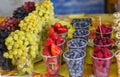 Oriental bazaar selling berries in cups in portions stand in a row on the counter