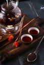 Oriental black tea with rosehip and hibiscus tea in glass teapot