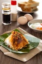 Oriental breakfast set in Malaysia consisting of coffee, nasi lemak, toast bread and half-boiled egg Royalty Free Stock Photo