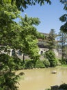 An oriental building and trees and pond