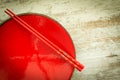 Oriental ceramic plate and chopsticks in red Royalty Free Stock Photo