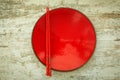 Oriental ceramic plate and chopsticks in red