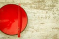 Oriental ceramic plate and chopsticks in red