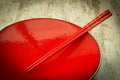 Oriental ceramic plate and chopsticks in red Royalty Free Stock Photo