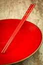 Oriental ceramic plate and chopsticks in red Royalty Free Stock Photo