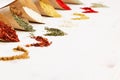 Oriental colorful powder condiments pattern as decorative border on white wooden board with copy space.