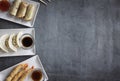 Oriental dishes, rustic concrete background. Space for text. Battered prawns, gyozas, spring rolls. Top view Royalty Free Stock Photo