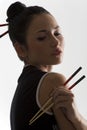 Oriental girl with chopstick