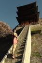 Oriental girl on steps of temple