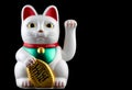 Oriental Good Fortune Waving Cat on a Black Background Royalty Free Stock Photo