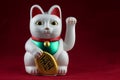 Oriental Good Fortune Waving Cat on a Mottled Red Background Royalty Free Stock Photo