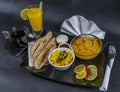 Oriental Indian set chicken korma naan bread, plate, coffee, orange juice, napkin, peppers Royalty Free Stock Photo