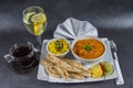 Oriental Indian set, chicken tikka masala, naan bread, white plate, black coffee, water, napkin, peppers