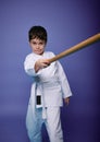 Oriental martial arts practice, combat, aikido, japanese sports and philosophy. Child boy fighter with wooden weapon bokken sword