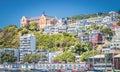 Oriental Parade boat sheds nestled below the iconic St Gerard`s Monastery