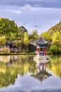 Oriental pavilion reflected in water at sunset, Lijiang, China. Royalty Free Stock Photo