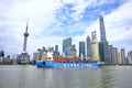 Oriental Pearl TV Tower Shanghai Bund buildings and large container ships on Huangpu River