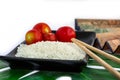 Oriental set of rice, tomatoes, chopsticks, green leaf and trans Royalty Free Stock Photo