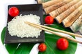 Oriental set of rice, tomatoes, chopsticks, green leaf and trans Royalty Free Stock Photo