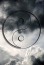 Oriental symbol yin yang over beautiful cloudy sky in gray white and black tonality