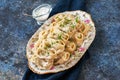 Oriental traditional food - Manty with minced beef or lamb meat in a plate with sauce on a blue background Royalty Free Stock Photo