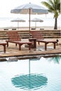 The oriental tropical beach resort. Wooden beach beds. White umbrellas at poolside with beach view