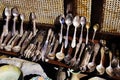 Oriental, Turkish, Azerbaijani antique collection of antique bronze tableware, brass bowl, jugs, spoons, forks, knives on display Royalty Free Stock Photo