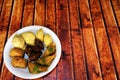 Oriental, Turkish, Azerbaijani baklava sweets in a white plate on a brown wooden table, copy space