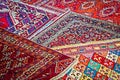 Oriental Turkish Persian rugs displayed at angles on sidewalk in Eurasia