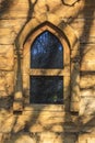 Oriental window on a log house with shadows on the wall