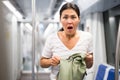 Oriental woman amazed by theft from her bag in subway car Royalty Free Stock Photo