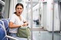 Oriental woman amazed by theft from her bag in subway car Royalty Free Stock Photo