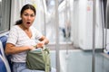 Oriental woman amazed by theft from her bag in subway car Royalty Free Stock Photo