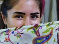 Oriental woman`s eyes with a silk traditional foulard in front of her face in Uzbekistan.