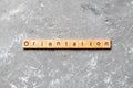Orientation word written on wood block. Orientation text on cement table for your desing, concept Royalty Free Stock Photo