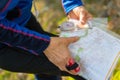 Orienteering athlete running through a summer forest with a map and compass. Royalty Free Stock Photo