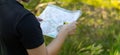 Orienteering athlete running through a summer forest with a map and compass. Royalty Free Stock Photo