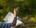 Orienteering athlete running through a summer forest with a map and compass. Royalty Free Stock Photo
