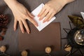 Origami is an ancient Chinese art of folding paper. Girl makes a figurine on a cozy brown background with lights and a warm lamp