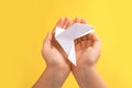 Origami art. Child holding paper bird on yellow background, closeup Royalty Free Stock Photo