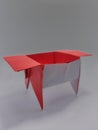 Origami art of paper folding with red paper and white background
