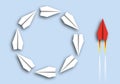 Concept of comparison between stupidity and intelligence, with origami planes running in circles and a red plane acting Royalty Free Stock Photo