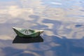 Origami boat built of one hundred dollar bill. paper boat from a hundred dollar bill in blue water. copy space. Concept: Royalty Free Stock Photo