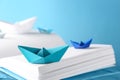 Origami boats on open book, closeup