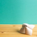 Origami fortune teller on wooden table with green copy space