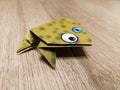 Origami frog close up on the wooden floow