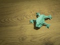 Origami Frog on wooden background